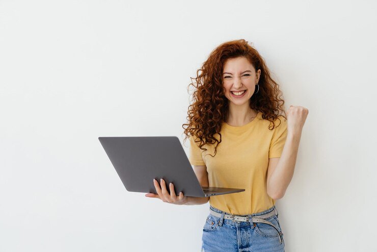 portrait-pretty-young-woman-celebrating-success-laptop-isolated-white-background_231208-14253